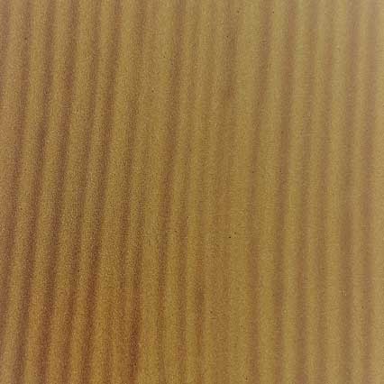 Rippled sand dunes with parallel ridges and valleys creating a natural wave-like pattern across a golden-brown desert surface.