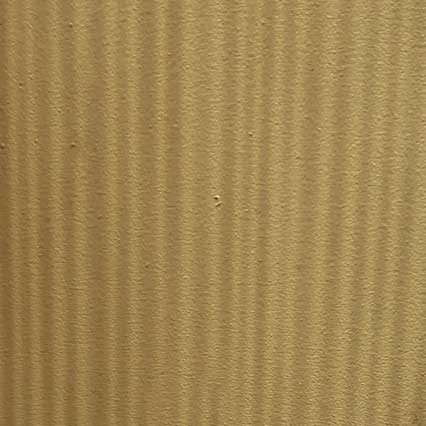 A close-up view of light-colored wood grain showing natural vertical striping patterns and texture in golden-brown tones.