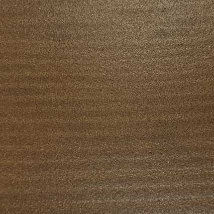 A close-up view of brown leather texture showing natural grain patterns and subtle variations in the surface.