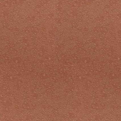 A reddish-brown textured surface with a fine, granular pattern resembling sandpaper or cork material.