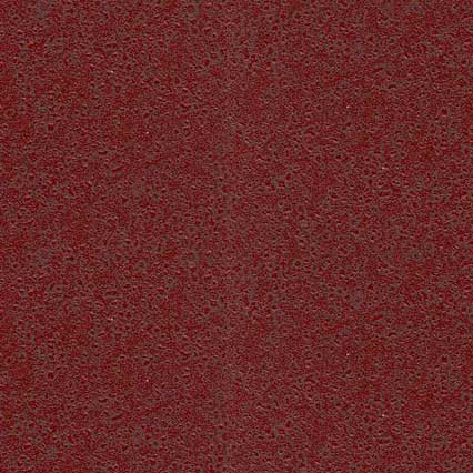 A textured deep red or burgundy surface with a fine, granular pattern resembling sandpaper or rough fabric material.