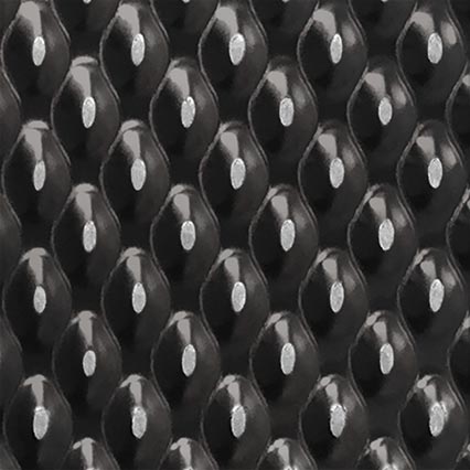 A repeating geometric pattern in black, white and gray featuring interlocking oval or eye-like shapes arranged in diagonal rows across the entire surface.