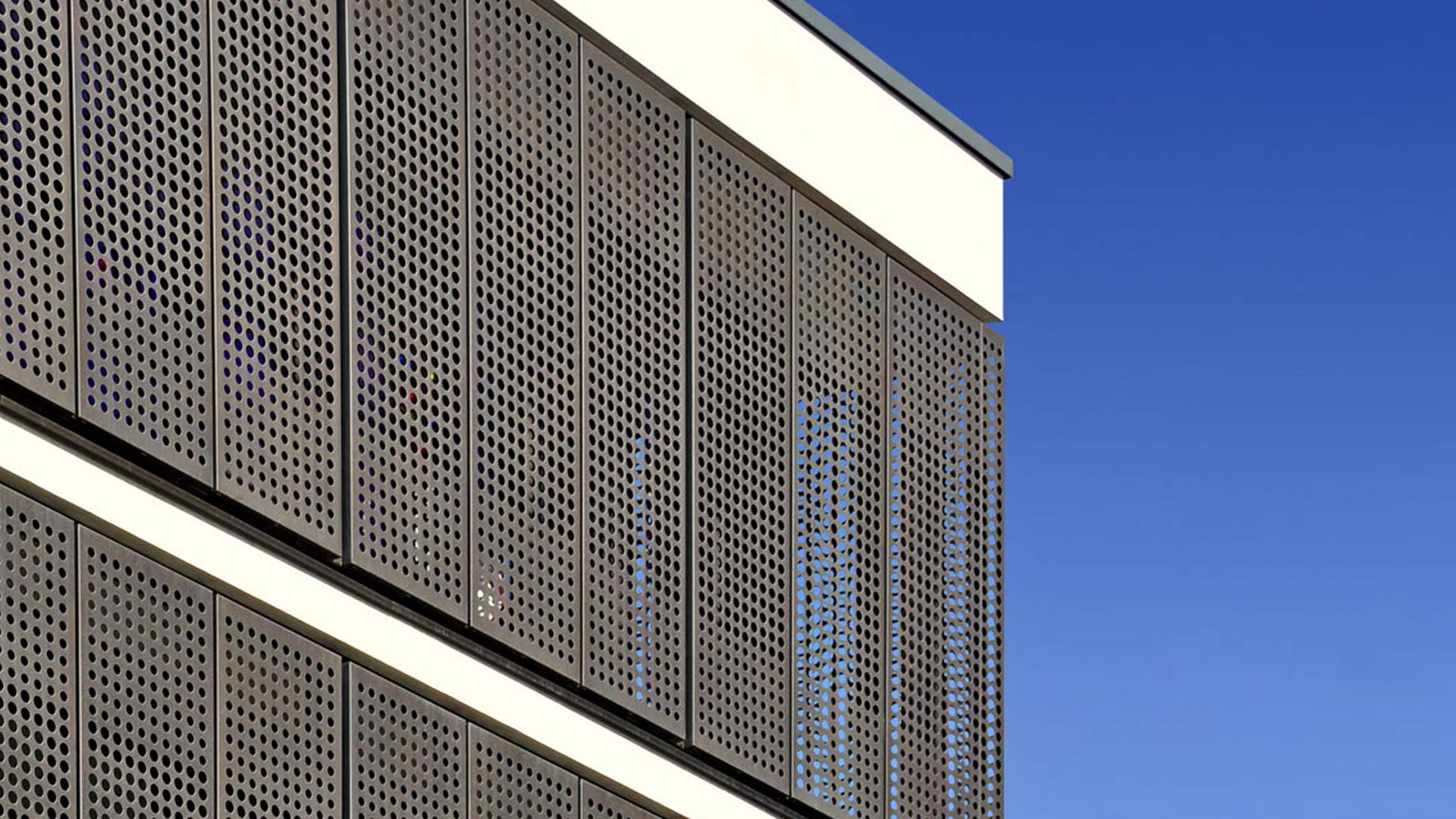 Perforated cladding panels in brass
